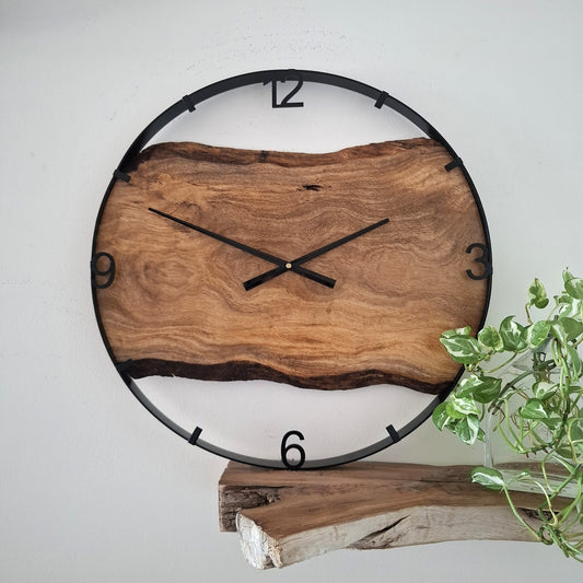 Wooden wall clock with natural finish on a white background