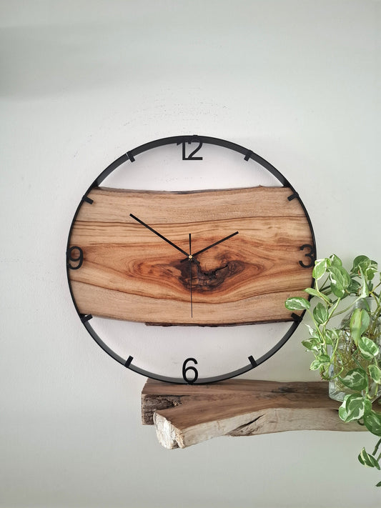 Wooden wall clock with natural finish on a white background