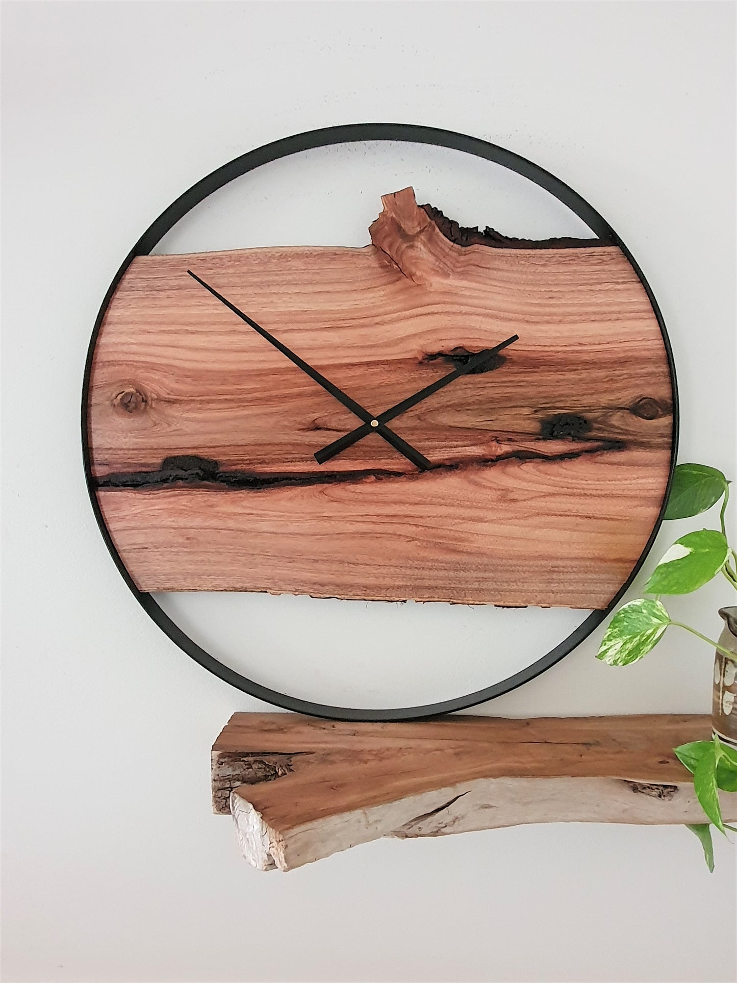 Custom made Wooden wall clock with natural edge design on a white wall.