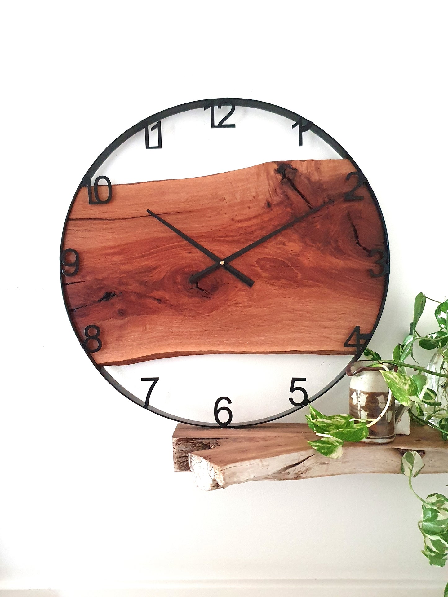 Wooden wall clock with natural finish on a white background