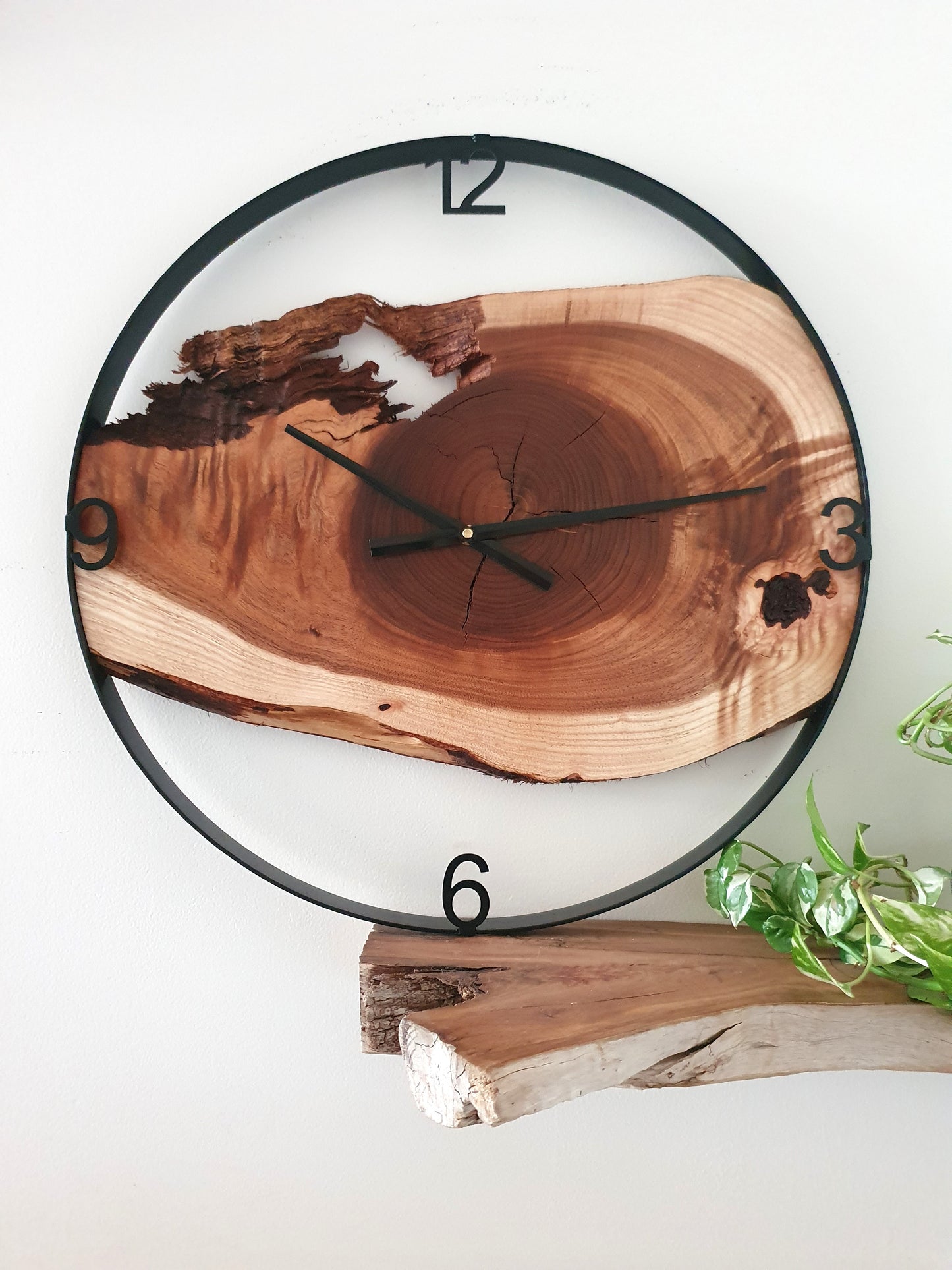 Wooden wall clock with natural edge design on a white background