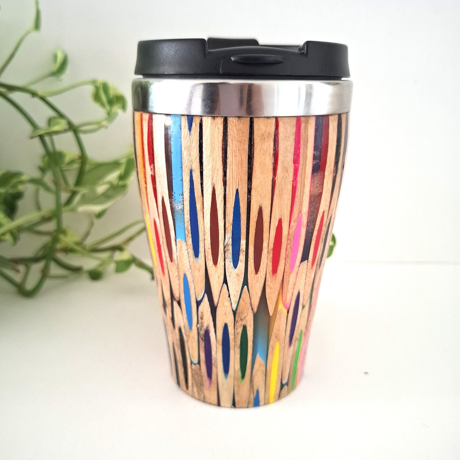 Colorful wooden-patterned travel mug with a black lid on a white background