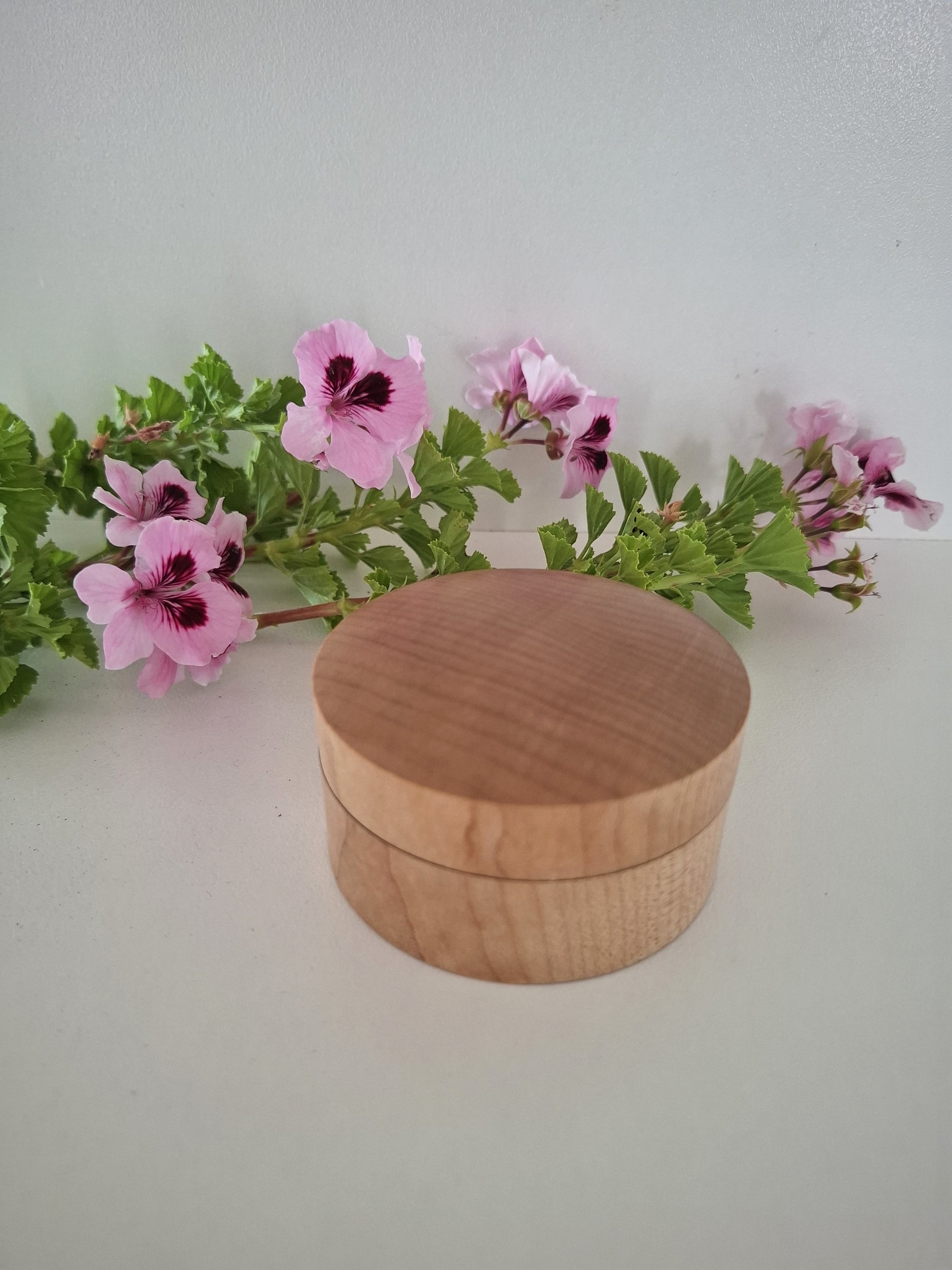 Wooden Ring Box with a lid on a white background with pink flowers and green leaves.