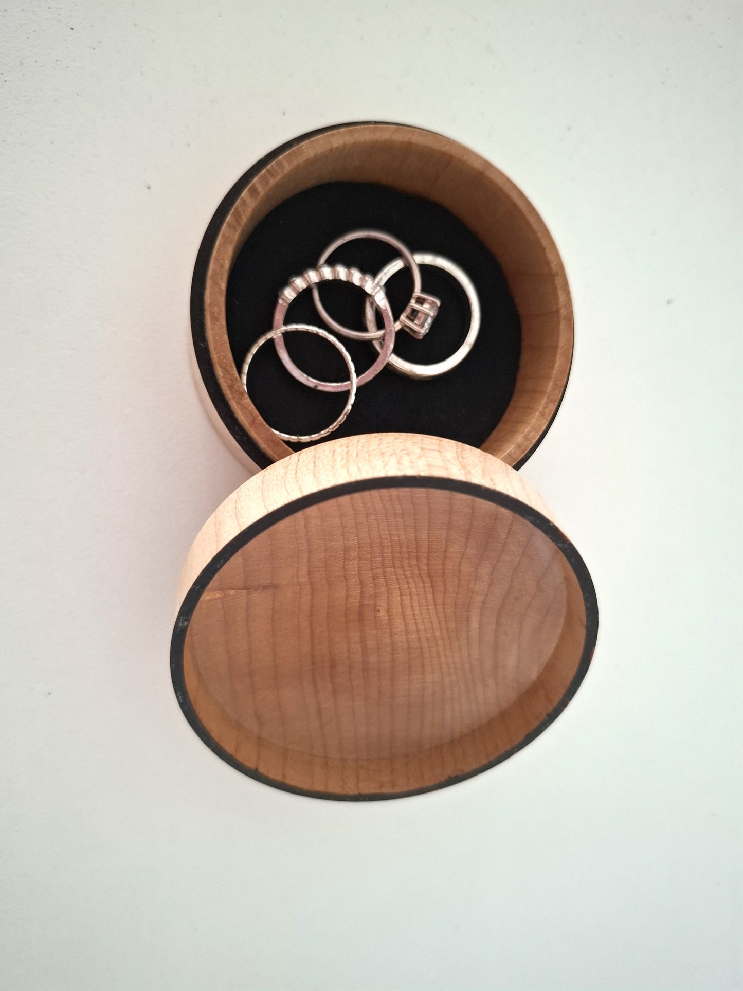 Wooden jewelry box with rings inside on a white background